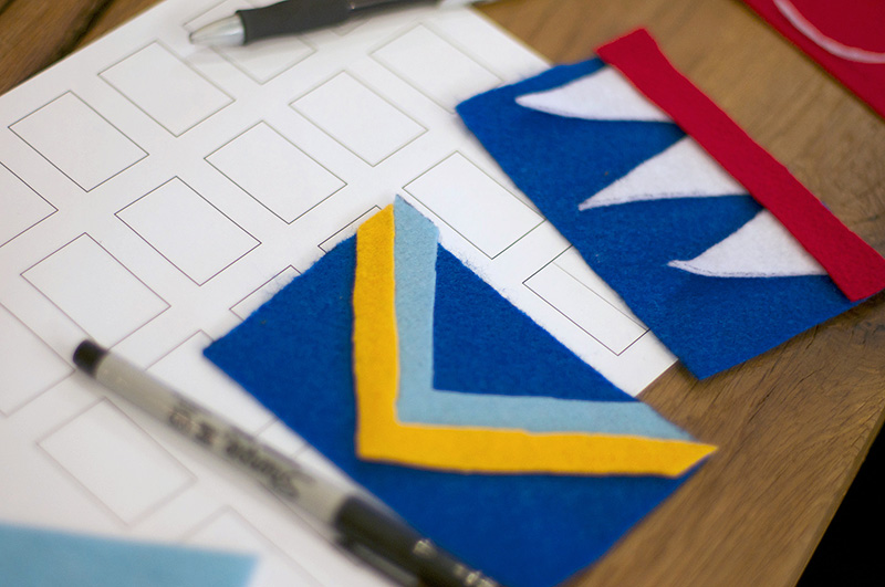 Two felt flag designs and sketching materials